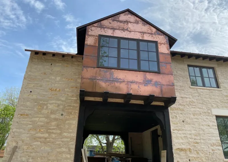 Copper metal panel facade on a stone building for Skylight Installation in Glen Allen